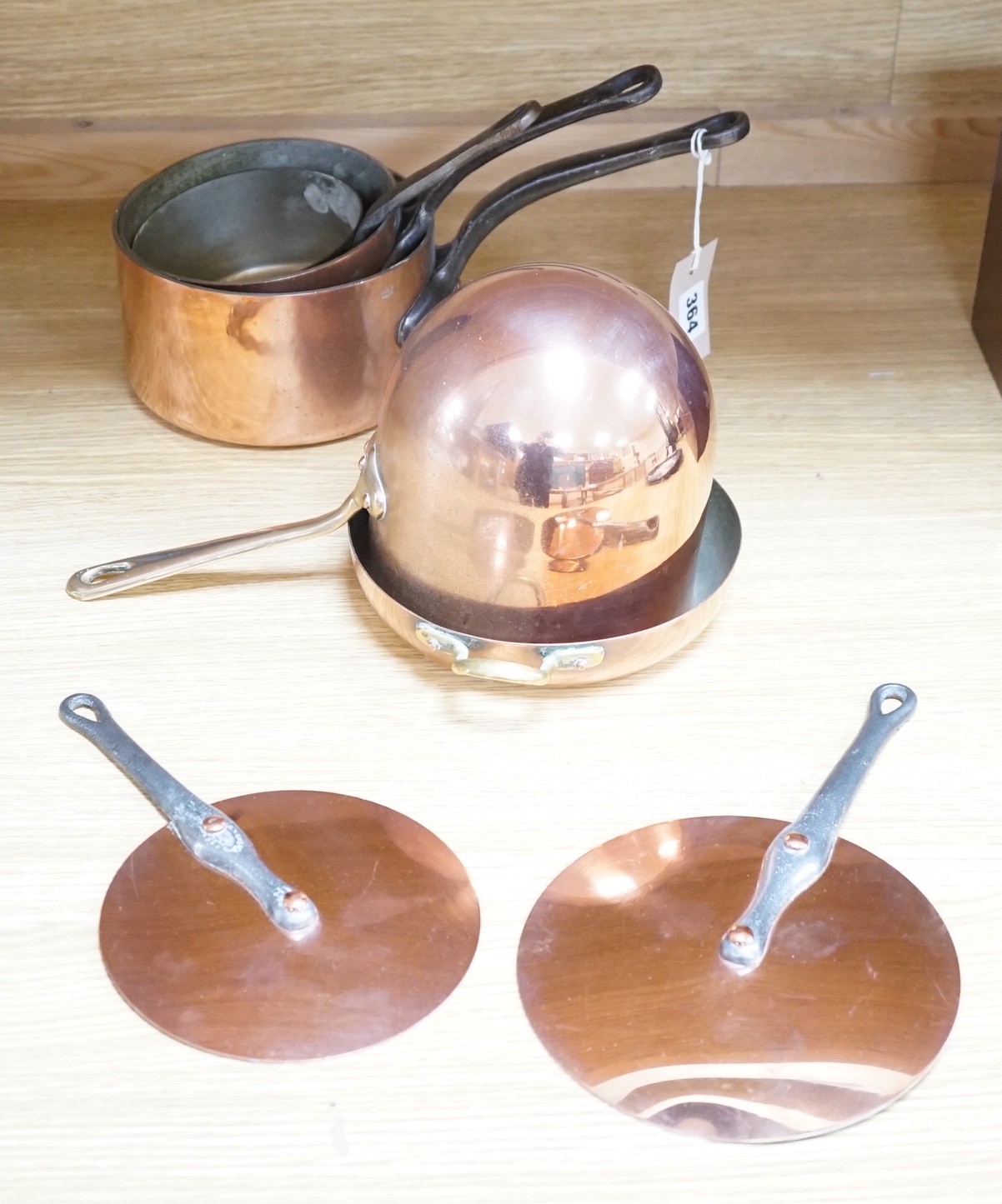 A quantity of copper pans including a zabaglione brass handled pan